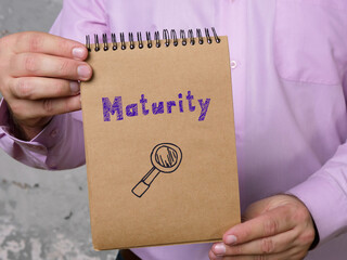 Business concept meaning Maturity with sign on the piece of paper.