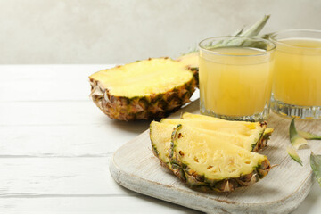Concept of breakfast with pineapple and glasses with juice on wooden table