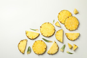 Flat lay with pineapple slices on white background, top view
