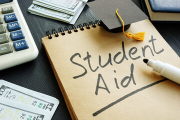 Student aid sign with small graduation cap and money. - obrazy, fototapety, plakaty