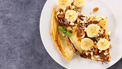 crepe with chocolate and banana with nuts