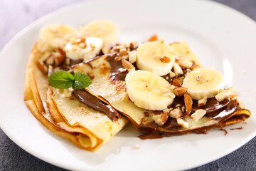 crepe with chocolate and banana with nuts