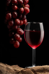 Still life of a bunch of grapes and a glass of wine