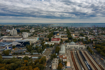 Fototapeta premium Main train station of Odessa Ukraine and city landscape. Drone footage, cloudy sky..