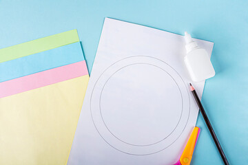 DIY and kids creativity. Step by step instruction: how to make paper easter wreath. Step2 draw circle on white paper with pencil. Childrens handmade Easter craft.