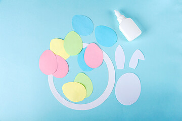 DIY and kids creativity. Step by step instruction: how to make paper easter wreath. Step5 cut out bunny blanks from white paper. Childrens handmade Easter craft.