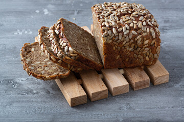 Sliced rye bread on cutting board. Whole grain rye bread with seeds