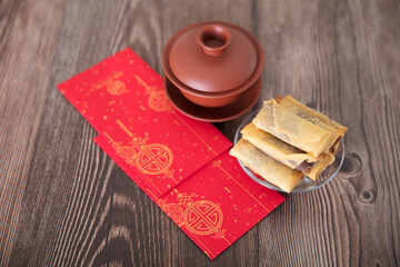 Fried spring rolls, tea and red envelopes on the table at the beginning of spring in China