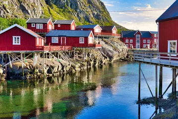 Fotobehang fisherman's houses rorbuer on the shore of a fjord in the sea in A Å Lofoten Norway © Tim