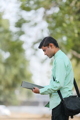 Young indian college student or job seeker with Holding file in Hand.