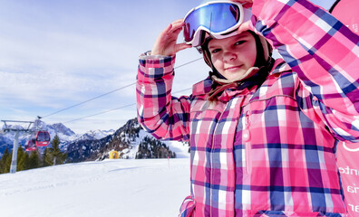 
Portrait of beautiful woman with ski and ski suit in winter mountain 