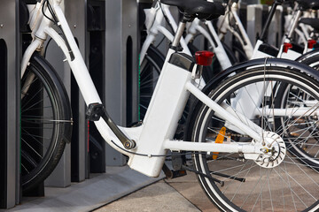 Urban electric bikes charging batteries in the city. Transportation