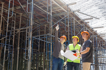 Fototapeta premium Construction concept of Engineer and Architect working at Construction Site with blue print