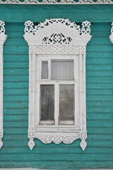 Ornamental window with carved frame on vintage wooden rural house in Nerekhta town, Kostroma...