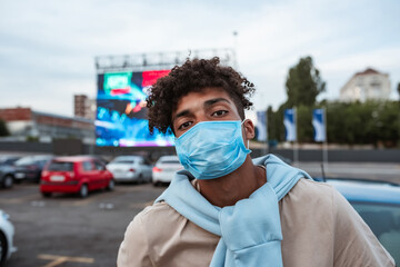 Young man at car cinema during coronavirus pandemic