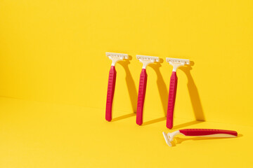 Studio shot of disposable razor tools on yellow