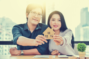 Hand hold house, Couple buying house for family future concept business investment finance insurance rent