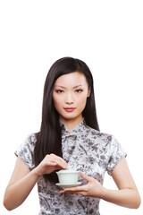 Wear cheongsam Oriental young female holding a cup of tea