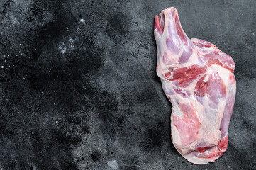 Raw lamb shoulder meat. Black background. Top view. Copy space