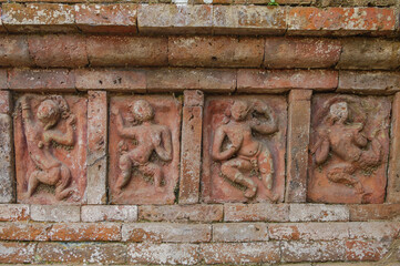 Carved terracotta plaques representing dancers on UNESCO World Heritage site ancient Somapura Mahavihara better known as Paharpur buddhist monastery in Naogaon, Bangladesh