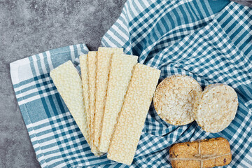 Assorted crackers on a marble background with a tablecloth