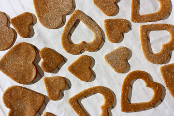 Heart shaped homemade dough gluten free chip cookies on the baking sheet ready for the oven for baking.Birthday,Valentine's day,Mothers day. Top view