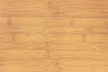The texture of the smooth lacquered surface of the bamboo table.