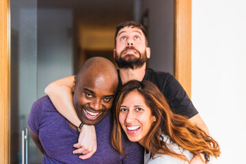 Three interracial friends making silly faces and having fun