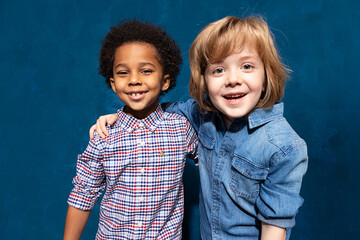 Portrait of two happy laughing multiracial friends schoolboys. Multiethnic friendship of two kids,...