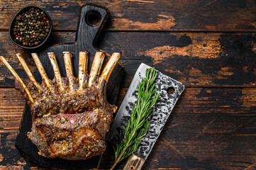 Grilled rack ribs of lamb meat chops. Dark wooden background. Top view. Copy space