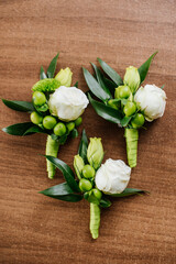 wedding buttonholes on wooden background