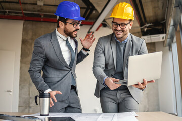 Two architect in building in construction process talking and brainstorming about innovations in their project.