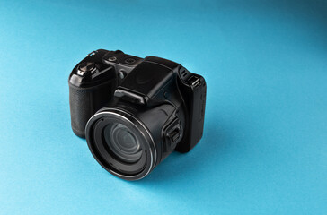 Compact camera on a blue background. Photography as a hobby, an idea for topics