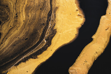 Diffuse liquid gold on black. Golden wave and bubbles. Abstract liquid marble background or...