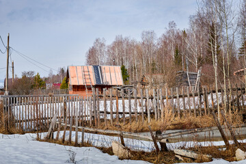Fototapeta na wymiar Traditional Russian village with an old house in spring