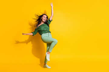 Photo portrait full body view of woman standing on one hand blown away isolated on vivid yellow colored background with blank space