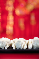 A plate of festival dumplings on a red background
