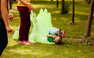 the little boy unsuccessfully descended from a children's slide
