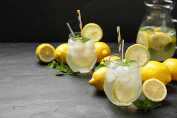 Natural lemonade with mint on grey table, space for text. Summer refreshing drink