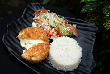Camembert schnitzel with rice and salad