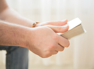 The Christian holds the Bible in his hands. Reading the bible. The concept of faith, spirituality and religion