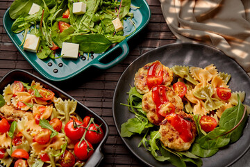 A variety of dishes on a dark background with the glare of the sun. Traditional chicken schnitzel...