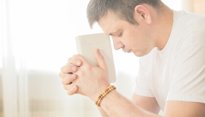 The Christian holds the Bible in his hands. The concept of faith, spirituality and religion. Prayer for prayer