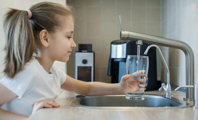 Little child open water tap. Kitchen faucet. Glass of clean water. Pouring fresh drink. Hydration. Healthy lifestyle. Good habit. Water quality check. World water monitoring day. Plastic free concept