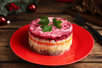 Herring under fur coat served on wooden table, closeup. Traditional russian salad