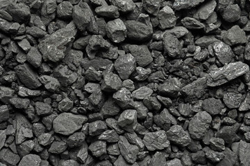 Heap of coal as background, top view