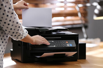 Employee using modern printer in office, closeup