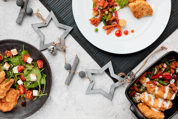 A variety of dishes. Traditional chicken schnitzel with herbs cherry tomato salad. Stewed...