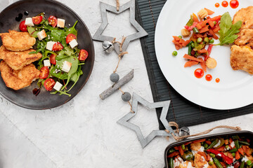 A variety of dishes. Traditional chicken schnitzel with herbs cherry tomato salad. Stewed...