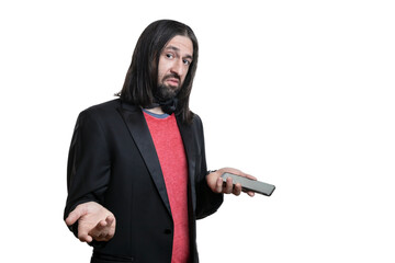 Portrait of a young man with long hair and a goatee in a black leather jacket and red T-shirt with a phone in his hands isolated on a white background. The concept of human emotions.